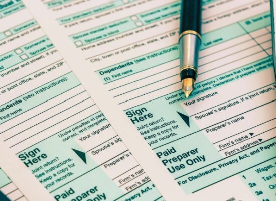 Tax Forms with Calculator and Pen. Financial accounting