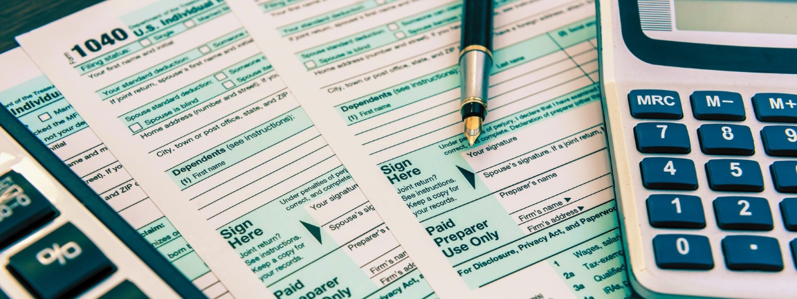 Tax Forms with Calculator and Pen. Financial accounting