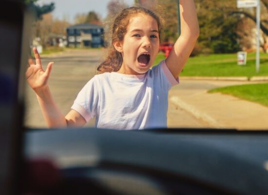 Little girl screaming before being hit by car because driver has cell phone and texting while driving Seen from inside car driver point of view