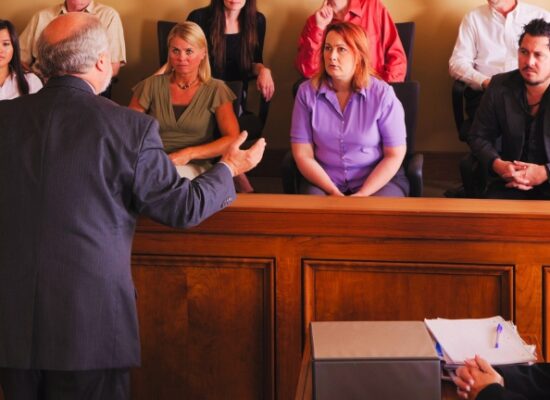 A lawyer in a courtroom talking to the jury.