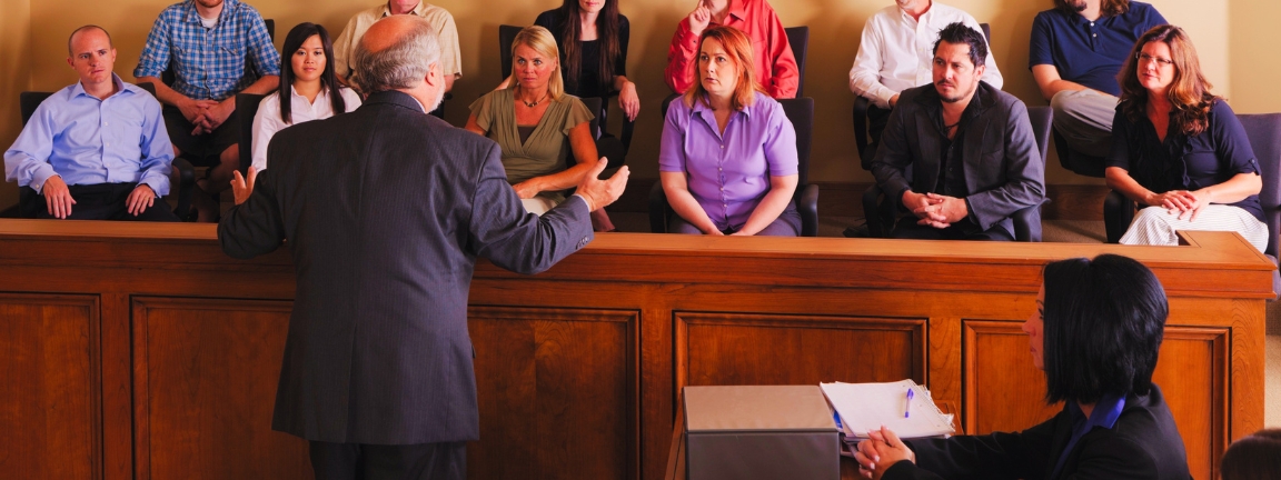 A lawyer in a courtroom talking to the jury.