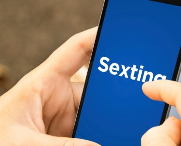 woman with sexting phone in the park