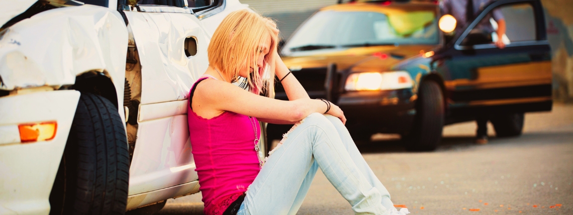 A police officer at a car accident scene.