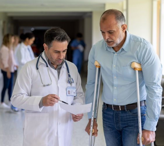 man on crutches next to a doctor