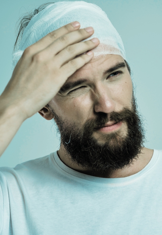 bearded man with bandaged head