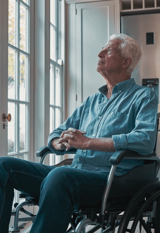 Cropped shot of a senior man sitting in his wheelchair at home