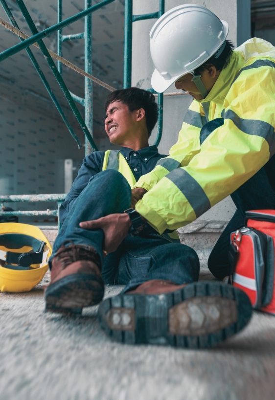 Accident at work of construction worker at site. Builder accident falls scaffolding on floor, Safety team helps employee accident.