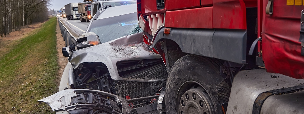 Car after a collision with a heavy truck. Concept of common causes of truck accident