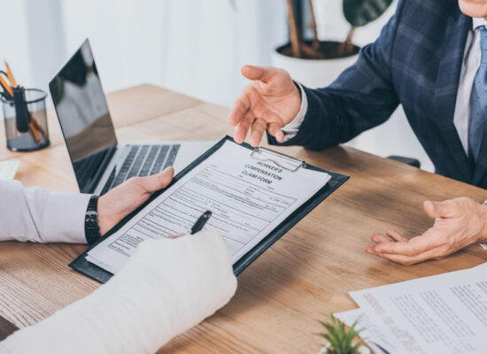 Bloomington Illinois Workers Compensation Attorney portrayed by hurt victim reviewing claim.