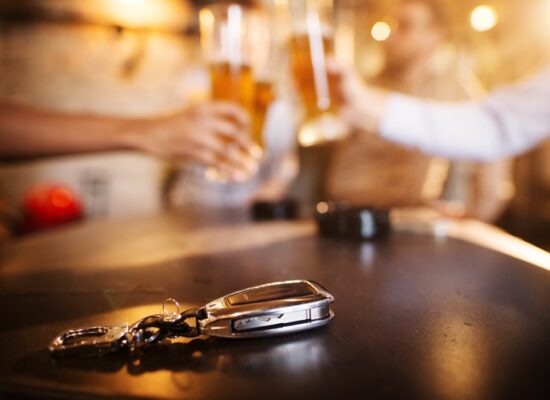 Bloomington Illinois dram shop lawyer Terry Dodds at Dodds Law Office portrayed by cheers with beers and car keys at a local bar.